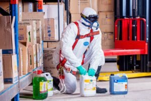 Pest control technician wearing safety gear preparing treatment chemicals